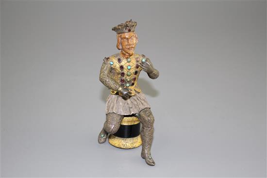 An Austro-Hungarian gilt and white metal figure of a seated knight, with jewelled decoration and hardwood head, height 11.5cm